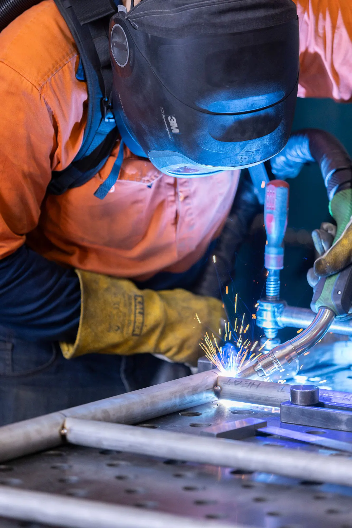 A Moduplay fabricator welding playground equipment